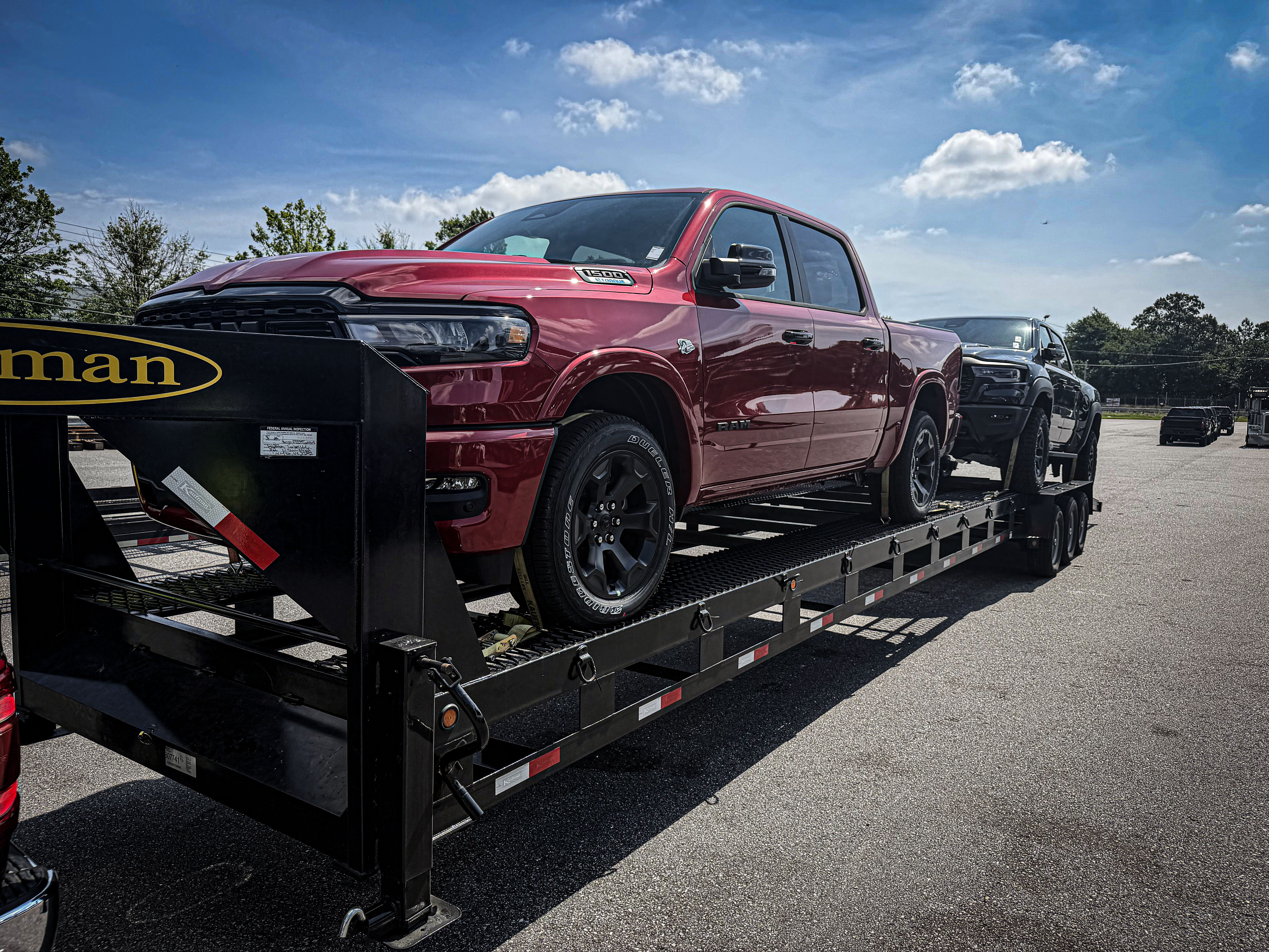 New pickup trucks on a vehicle transport trailer